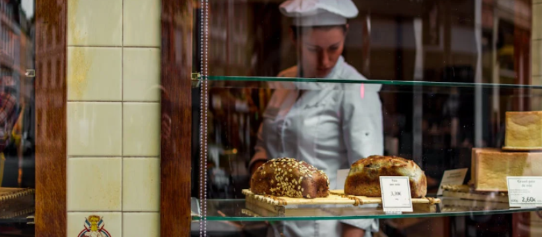 Bakery shop window displaying a variety of breads