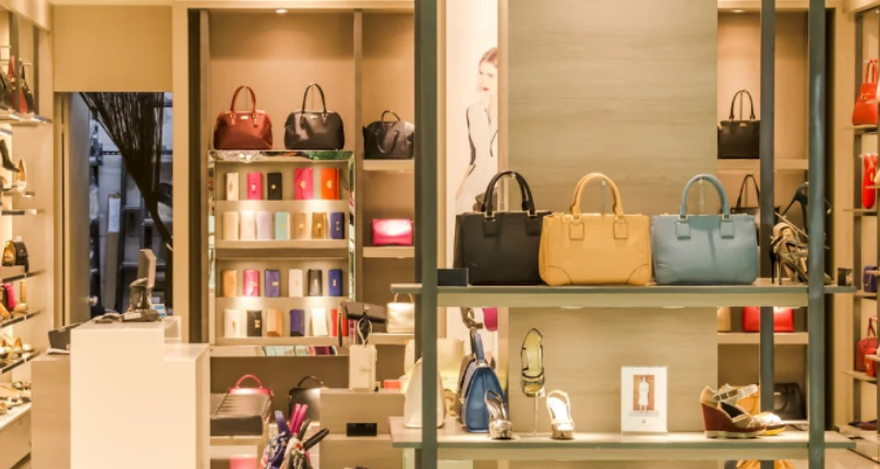 Showroom displaying ladies' shoes, bags, and purses neatly arranged