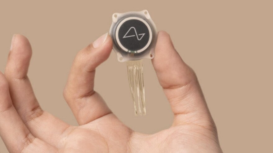 From Words Lost in the Air to Words Written by AI 8 Neuralink brain-computer interface implant held between fingers